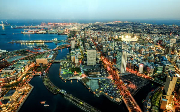 Aerial Yokohama cityscape, Japan at dusk with illuminated harbor, bridges and skyscrapers — 2K Quad HD PC desktop wallpaper/background.