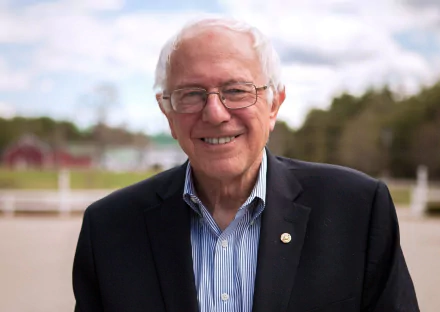 HD desktop wallpaper featuring Bernie Sanders smiling outdoors, suitable as a background.