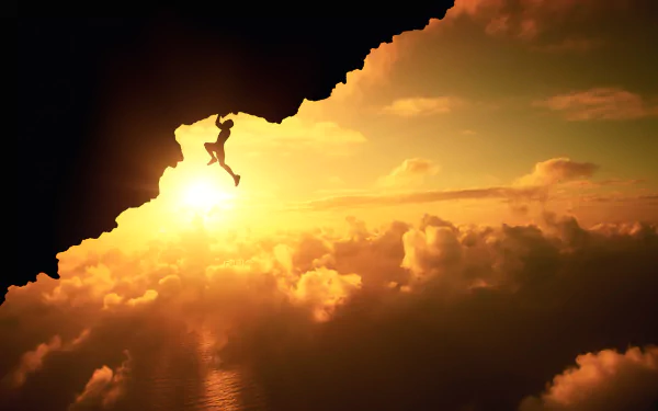 A silhouetted climber ascends a rocky ledge against a stunning sunset, with vibrant clouds filling the sky, capturing the spirit of adventure and outdoor sports.