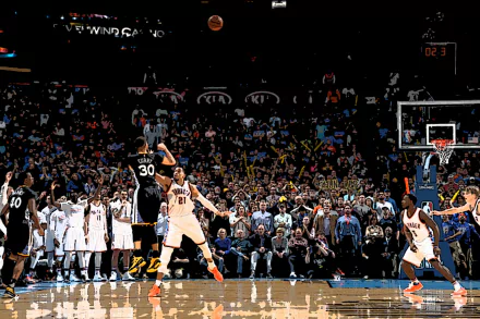 HD wallpaper featuring a basketball player shooting during a game with an excited crowd in the background.