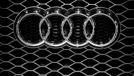 HD desktop wallpaper featuring the Audi logo with a black hexagonal pattern background.