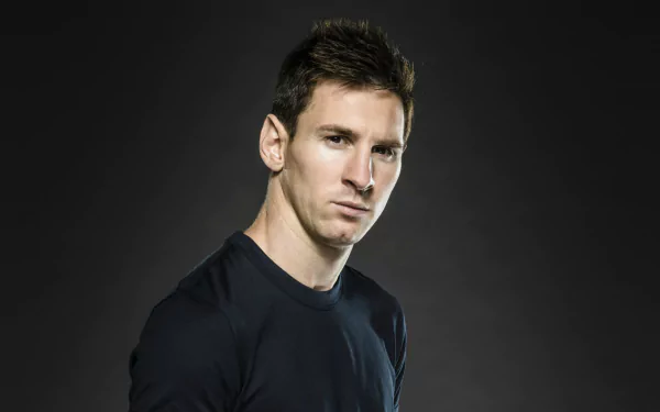 HD desktop wallpaper featuring a person, sporting a dark blue top against a gradient black background.