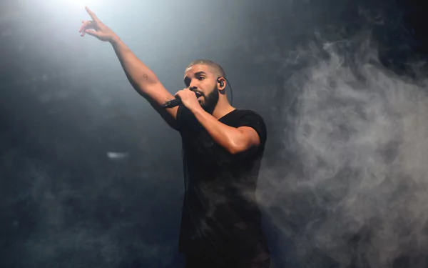HD wallpaper of a performer on stage with a raised finger, surrounded by atmospheric stage smoke, creating an energized backdrop.