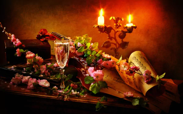 A still life HD desktop wallpaper featuring a violin, glowing candles, sheet music, vibrant flowers, and a glass flute, captured in warm, artistic photography.