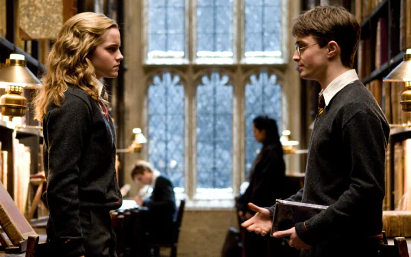 Emma Watson as Hermione Granger and Daniel Radcliffe as Harry Potter in a library scene from Harry Potter and the Half-Blood Prince. A HD desktop wallpaper showcasing characters in a school setting.