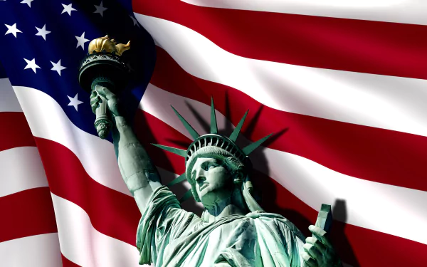 4K Ultra HD desktop wallpaper featuring the Statue of Liberty against a waving American flag, celebrating the spirit of the 4th of July holiday.
