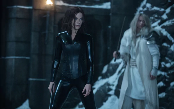 HD desktop wallpaper of Selene (played by Kate Beckinsale) from the movie Underworld: Blood Wars. Selene is seen in her iconic black outfit, with a snowy, cave-like background.