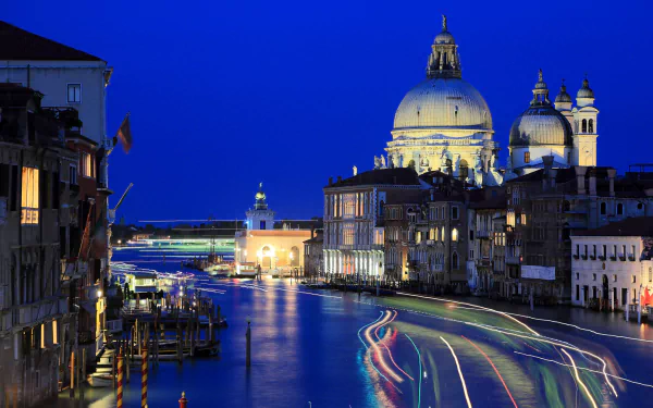 Nighttime time-lapse view of Venice’s Grand Canal with illuminated historic buildings under a deep blue sky, captured in high-definition for a PC desktop wallpaper.