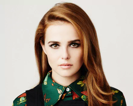 HD PC desktop wallpaper: close-up headshot of a red‑haired celebrity actress in a patterned green blouse, neutral expression against a pale background (identity unspecified).