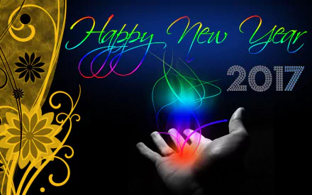 HD desktop wallpaper celebrating New Year 2017. Colorful Happy New Year text and luminous designs above an open hand, with a yellow floral pattern on the left.
