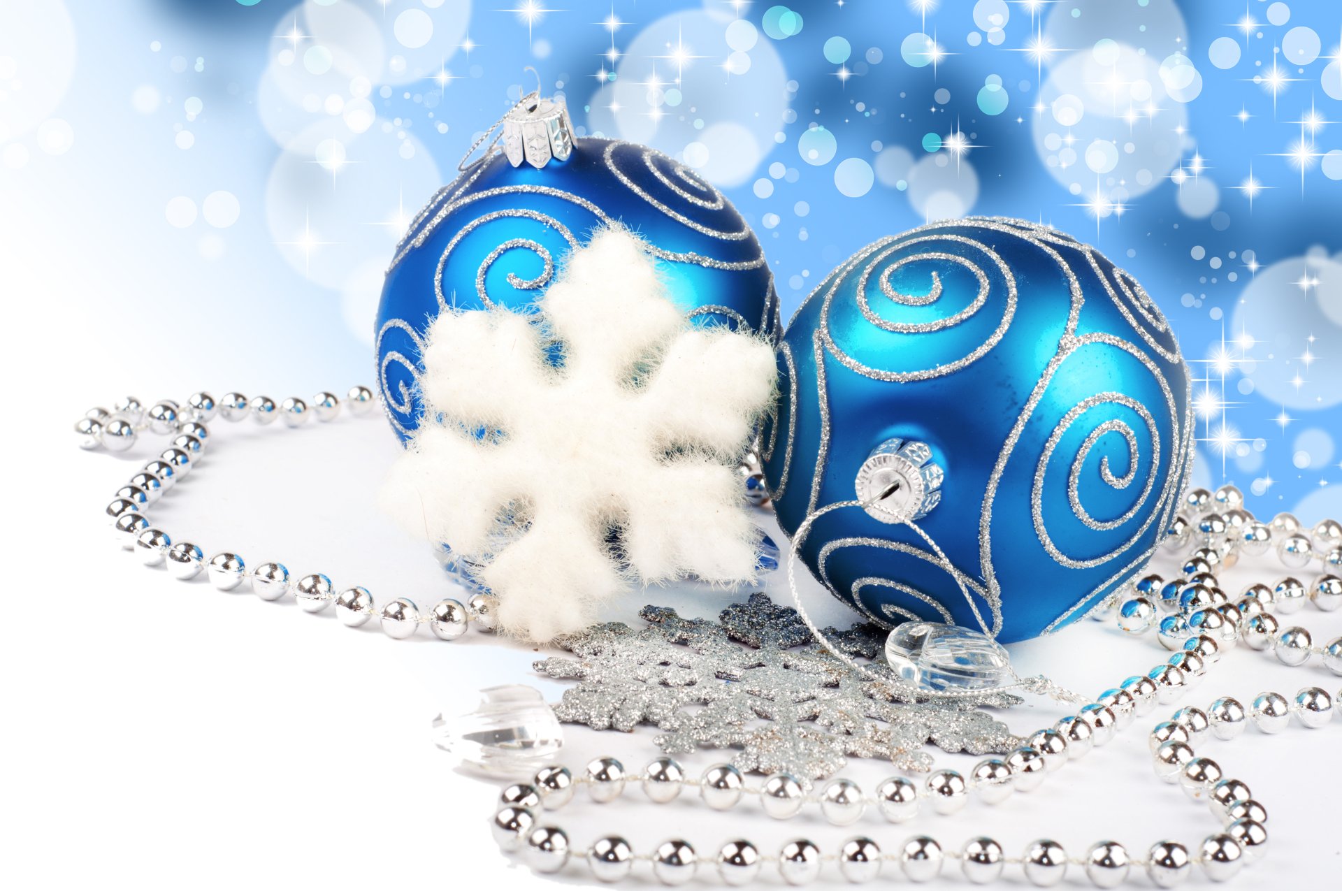 A silver and blue holiday scene featuring Christmas ornaments, snowflakes, and silver beads on a softly blurred background, captured in 8K Ultra HD quality.