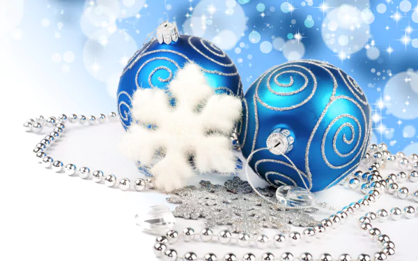 A silver and blue holiday scene featuring Christmas ornaments, snowflakes, and silver beads on a softly blurred background, captured in 8K Ultra HD quality.