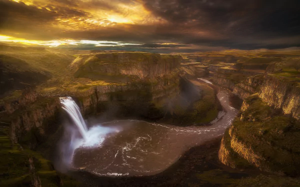 HD desktop wallpaper showcasing Palouse Falls cascading into a winding canyon river at sunset, highlighting dramatic skies and rugged natural beauty.