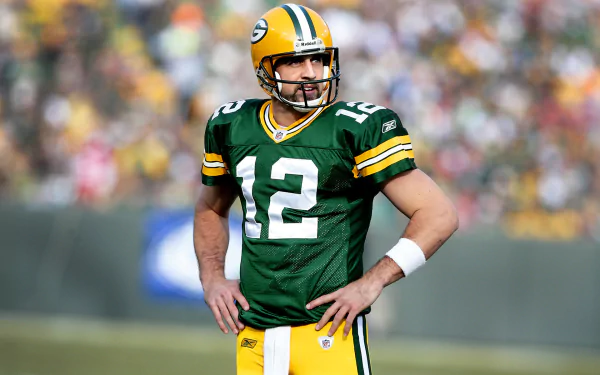 Aaron Rodgers in a Green Bay Packers #12 jersey on the field, HD desktop wallpaper.