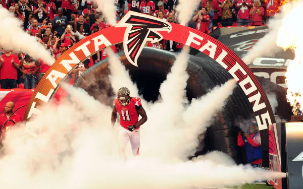 HD wallpaper of Julio Jones emerging from smoke at an Atlanta Falcons game.