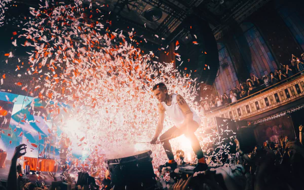 HD desktop wallpaper of a Twenty One Pilots concert with vibrant confetti explosion and an energetic performance.