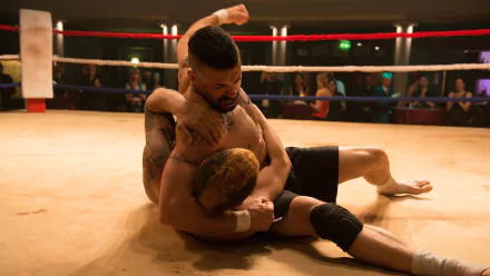HD PC desktop wallpaper from the movie Boyka: Undisputed IV, showing two fighters grappling intensely inside a boxing ring.
