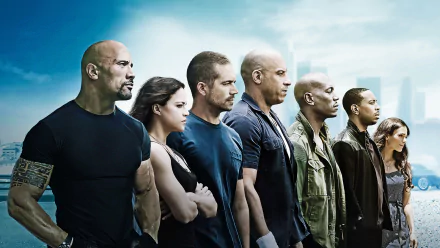 HD desktop wallpaper featuring the main cast of the movie Furious 7, standing side by side against a cloudy sky backdrop.