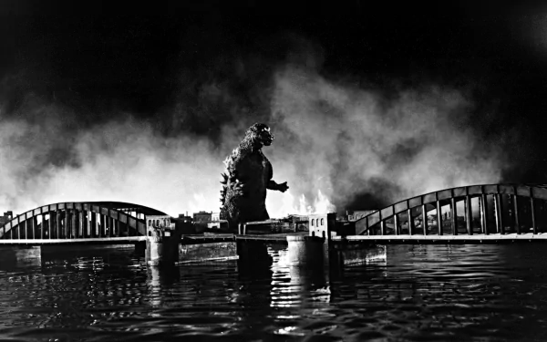 Black-and-white HD PC desktop wallpaper and background of Godzilla from the 1954 movie, stomping across a bridge amid smoke, its silhouette reflected on the water.