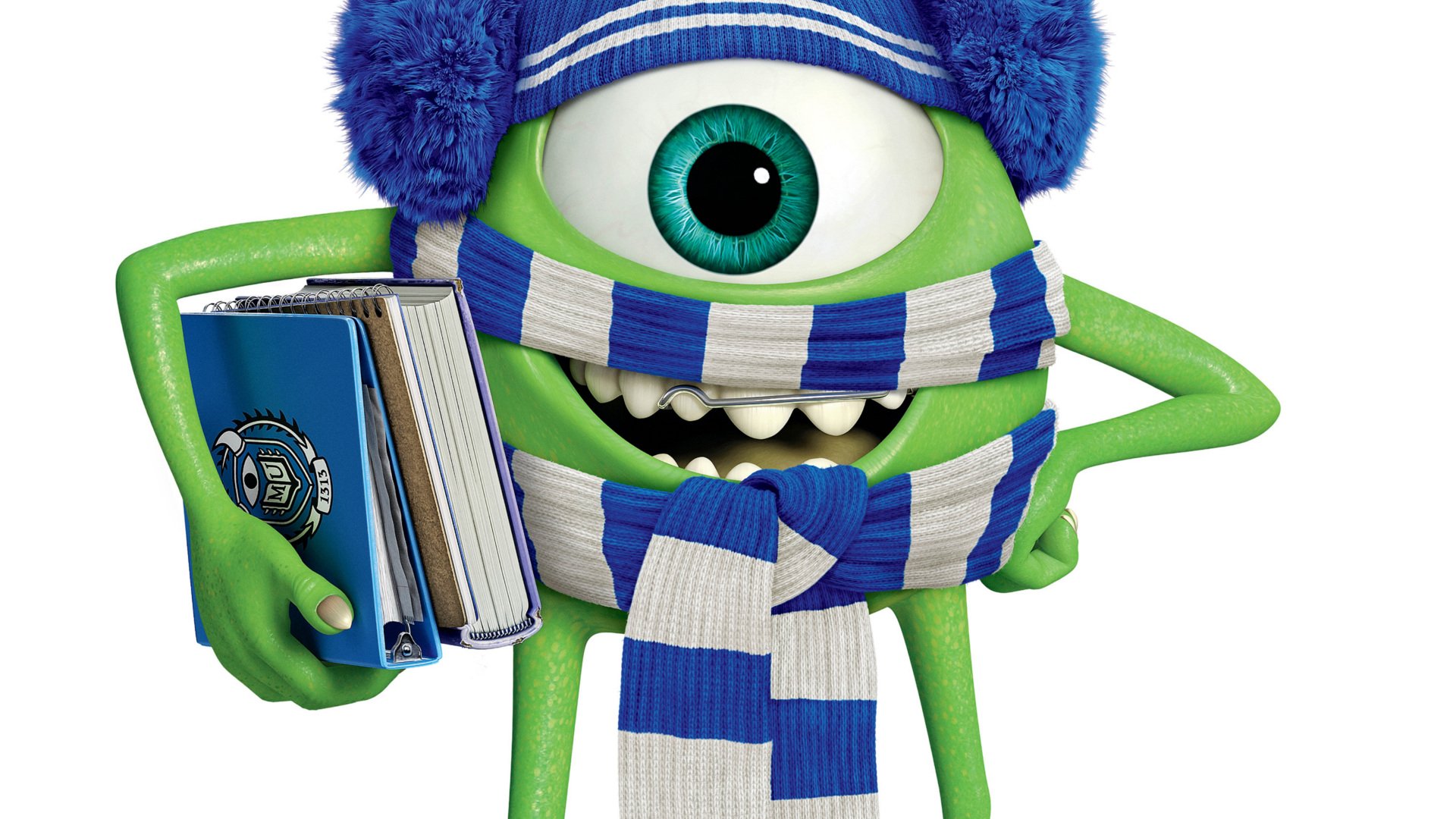 HD PC desktop wallpaper: Mike Wazowski from Monsters University wearing a blue knit hat and scarf, holding textbooks and grinning.