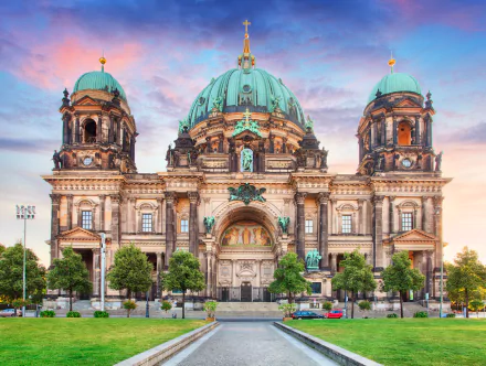 4K Ultra HD desktop wallpaper of Berlin Cathedral, Germany — majestic religious architecture with green domes and ornate façade bathed in warm sunrise light.