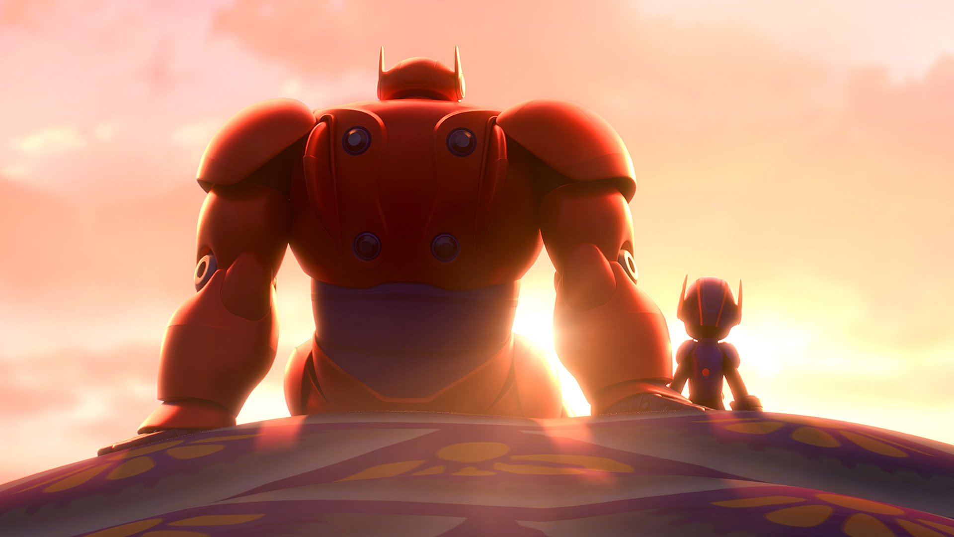 HD desktop wallpaper from the movie Big Hero 6, showing Baymax and Hiro standing side by side at sunset.