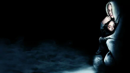 HD PC desktop wallpaper/background from the movie Case 39: a pale woman clutching a terrified child at right, shrouded in blue fog and shadow against a black, ominous backdrop.
