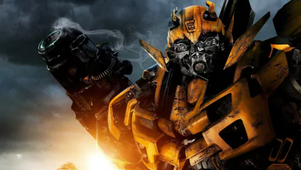 HD desktop wallpaper featuring a detailed image of Bumblebee from the movie Transformers: Revenge of the Fallen, showcasing his battle-worn armor against a dramatic sky backdrop.