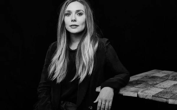 Black and white 8K Ultra HD portrait of American actress Elizabeth Olsen, captured with a calm and confident expression against a dark background.