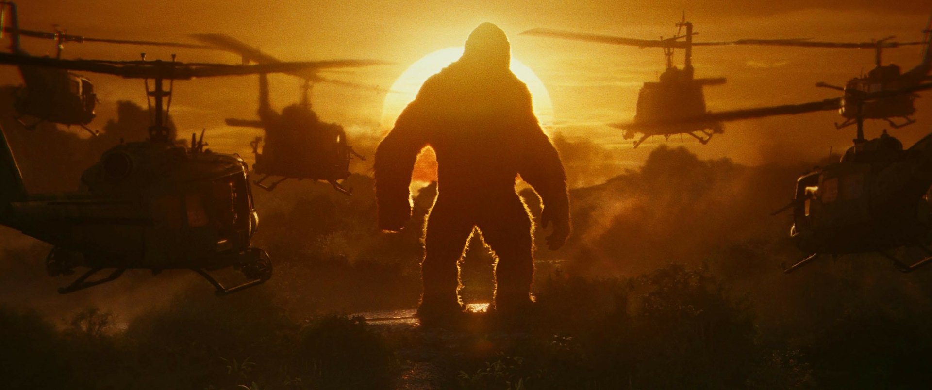 HD desktop wallpaper from Kong: Skull Island featuring Kong standing against a sunset, surrounded by helicopters.