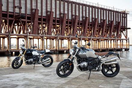 Two BMW R nineT motorcycles parked by a waterfront pier, highlighting BMW motorcycle design and vehicle detail — 4K Ultra HD PC desktop wallpaper/background.