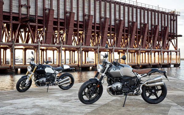 Two BMW R nineT motorcycles parked by a waterfront pier, highlighting BMW motorcycle design and vehicle detail — 4K Ultra HD PC desktop wallpaper/background.