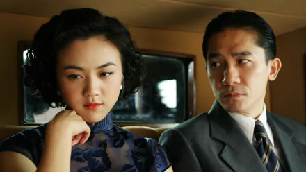 HD desktop wallpaper and background featuring a scene from the movie 'Lust, Caution,' with a woman and man sitting closely in a car, both looking tense and contemplative.