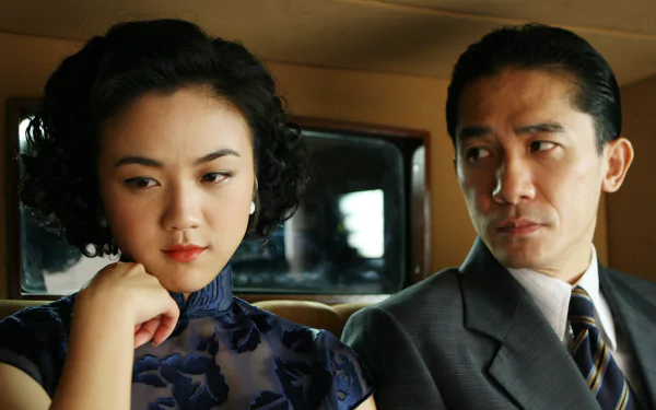 HD desktop wallpaper and background featuring a scene from the movie 'Lust, Caution,' with a woman and man sitting closely in a car, both looking tense and contemplative.