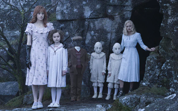 HD desktop wallpaper featuring characters from Miss Peregrine's Home for Peculiar Children, including appearances by Ella Purnell, Pixie Davies, and Lauren McCrostie, standing in a mystical forest setting.