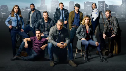 HD desktop wallpaper featuring the cast of Chicago P.D., centered on Hank Voight and other police characters from the TV show against a city skyline backdrop.