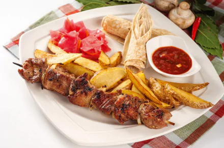 HD desktop wallpaper of a meal featuring barbecue meat skewers, French fries, tortilla, pickled vegetables, and a side of dipping sauce on a white plate.