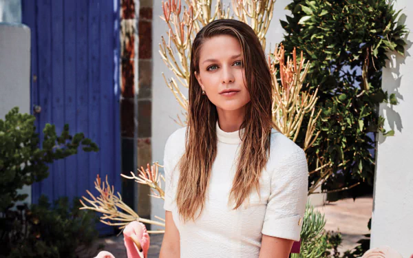 Portrait of American actress Melissa Benoist with blue eyes and blonde hair, set against a natural outdoor background in 4K Ultra HD quality.