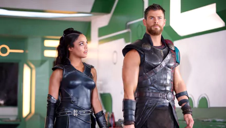 HD desktop wallpaper featuring Tessa Thompson and Chris Hemsworth in their roles from the movie Thor: Ragnarok, showcasing their costumes and intense expressions.