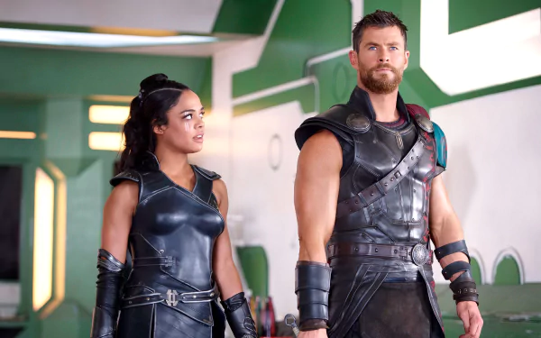 HD desktop wallpaper featuring Tessa Thompson and Chris Hemsworth in their roles from the movie Thor: Ragnarok, showcasing their costumes and intense expressions.