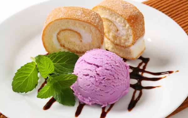 A 4K Ultra HD desktop wallpaper featuring a dessert plate with two slices of rolled cake, a scoop of purple ice cream, fresh mint leaves, and chocolate drizzle.