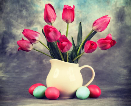 Still life of pink tulips in a white pitcher surrounded by colorful Easter eggs, captured in 4K Ultra HD as a vibrant Easter holiday desktop wallpaper.
