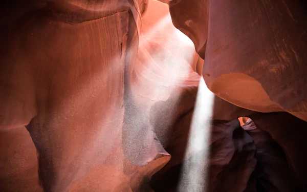 Sunbeam streams through narrow sandstone walls of Antelope Canyon, highlighting the natural textures in this 4K Ultra HD nature desktop wallpaper.