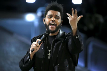 HD desktop wallpaper featuring a person with a microphone in mid-performance, expressive with one hand raised.