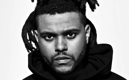 HD desktop wallpaper featuring a monochrome portrait of The Weeknd in a hoodie.
