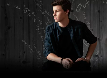 HD desktop wallpaper featuring a contemplative person sitting against a dark background with script.