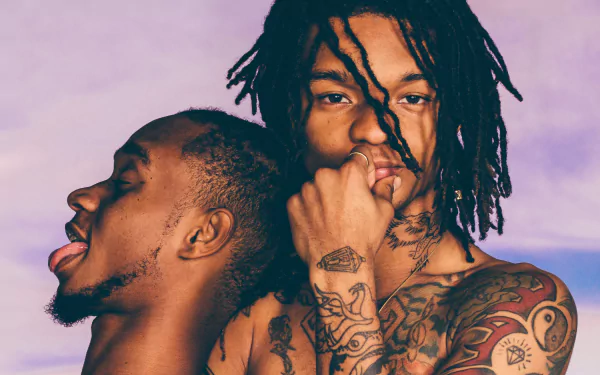 HD desktop wallpaper featuring Rae Sremmurd, with dynamic poses and intricate tattoos against a pastel background, capturing the essence of their music and style.
