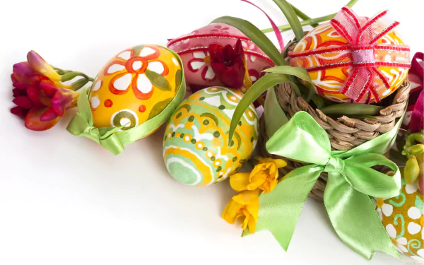 Colorful Easter eggs adorned with ribbons and flowers are displayed in a wicker basket, making a vibrant HD desktop wallpaper and background for the Easter holiday.