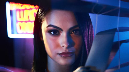 HD desktop wallpaper featuring Camila Mendes, actress from the TV show Riverdale, with vibrant neon lighting emphasizing her intense gaze.