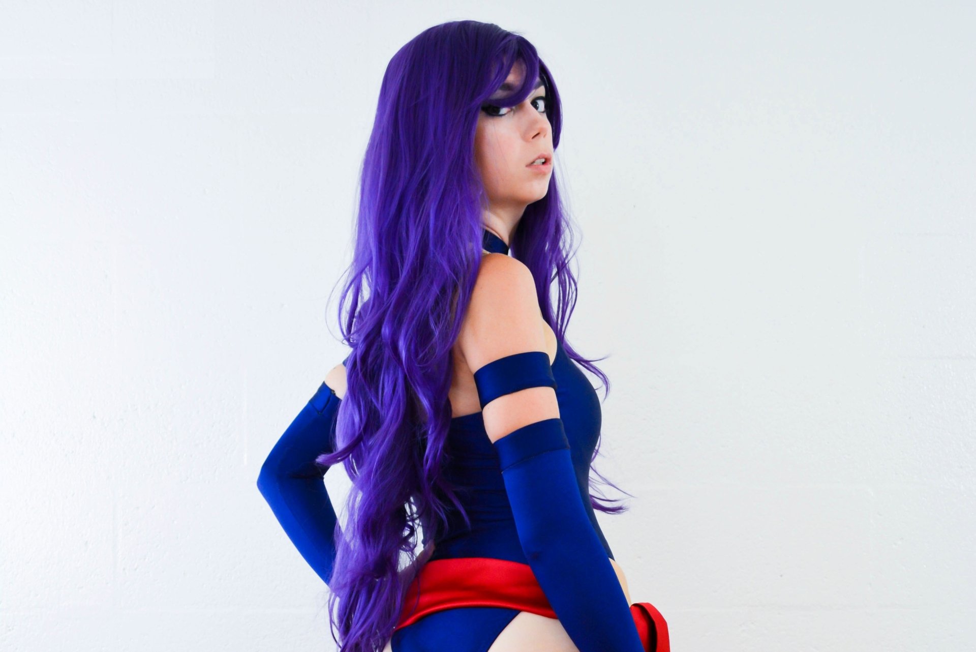 4K Ultra HD desktop wallpaper featuring a woman cosplaying Psylocke from X-Men, with long purple hair and a dark costume, tagged Uncanny Megan.